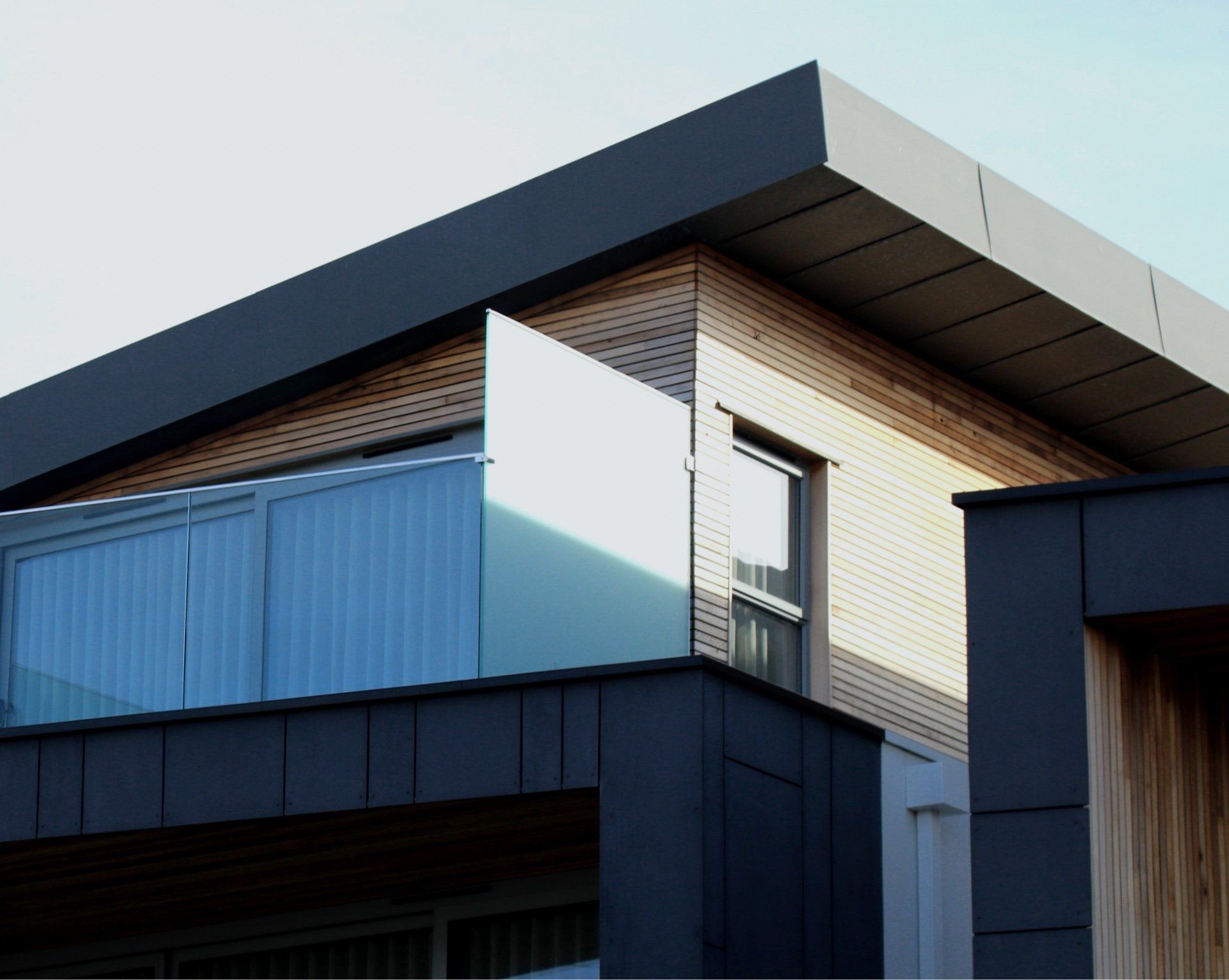 A house with a balcony and a glass railing